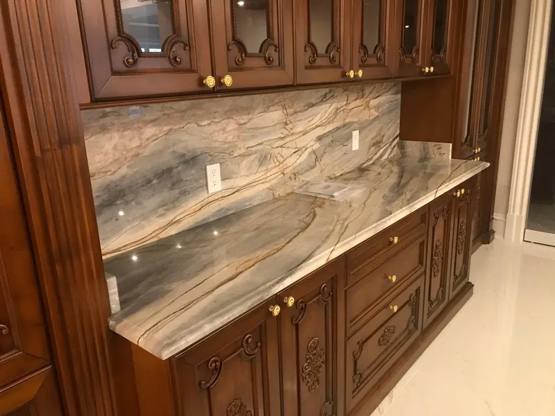 Bookmatched blue and gold veined stone backsplash – installed by Beltway Countertops in Leesburg, VA