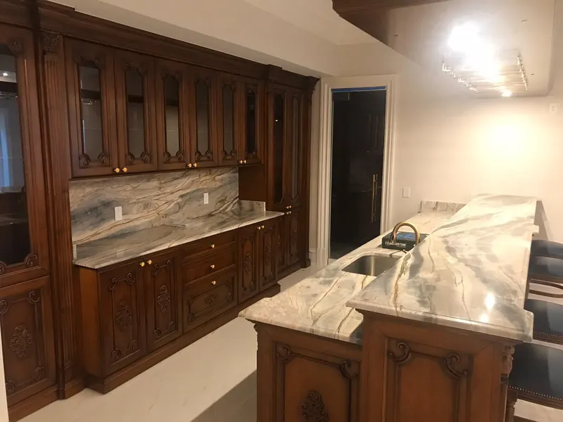 Blue and gold veined stone wet bar with a full-height backsplash – installed by Beltway Countertops in Leesburg, VA