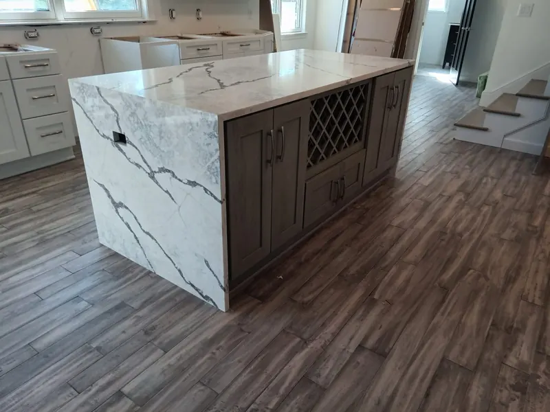 Calacatta-look waterfall island with a wine rack – Beltway Countertops, Northern Virginia