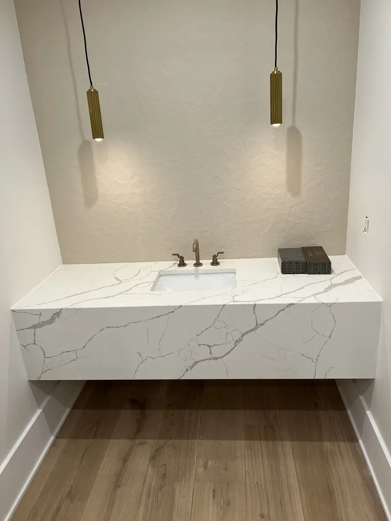 Floating Calacatta quartz vanity top in a powder room – installed by Beltway Countertops in Ashburn, VA