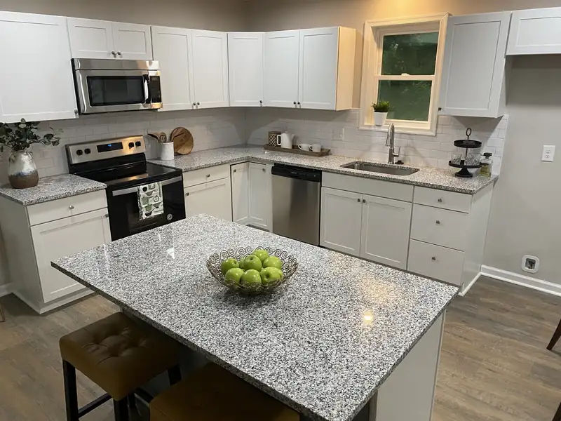 Gray and white granite kitchen and island with white shaker cabinets – installed by Beltway Countertops in Ashburn, VA
