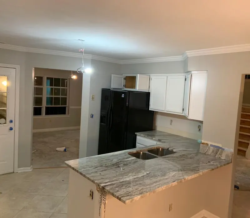 Gray veined stone peninsula with a double sink – installed by Beltway Countertops in Chantilly, VA