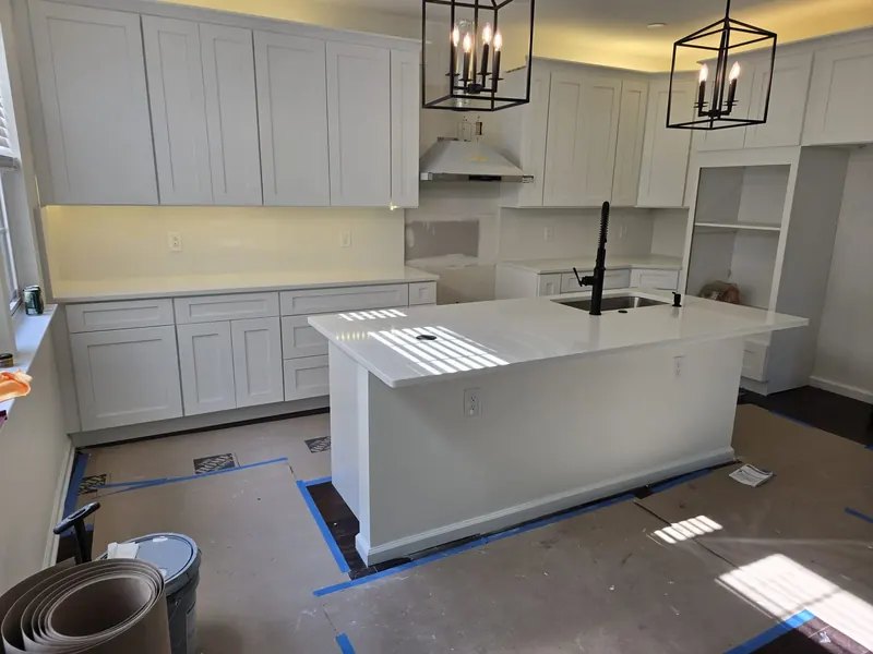 Pure white quartz island with black lantern pendants – Beltway Countertops, Northern Virginia