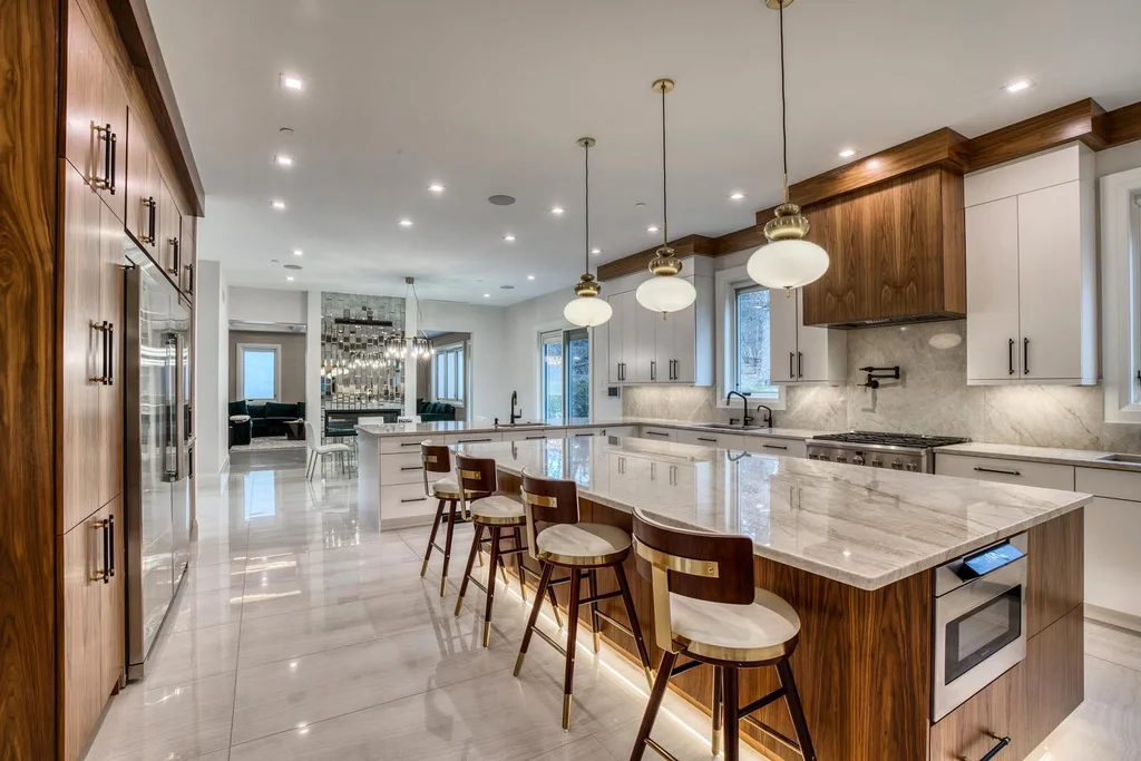 Taj Mahal stone countertops and full-height backsplash on a walnut kitchen island with white cabinets, installed by Beltway Countertops