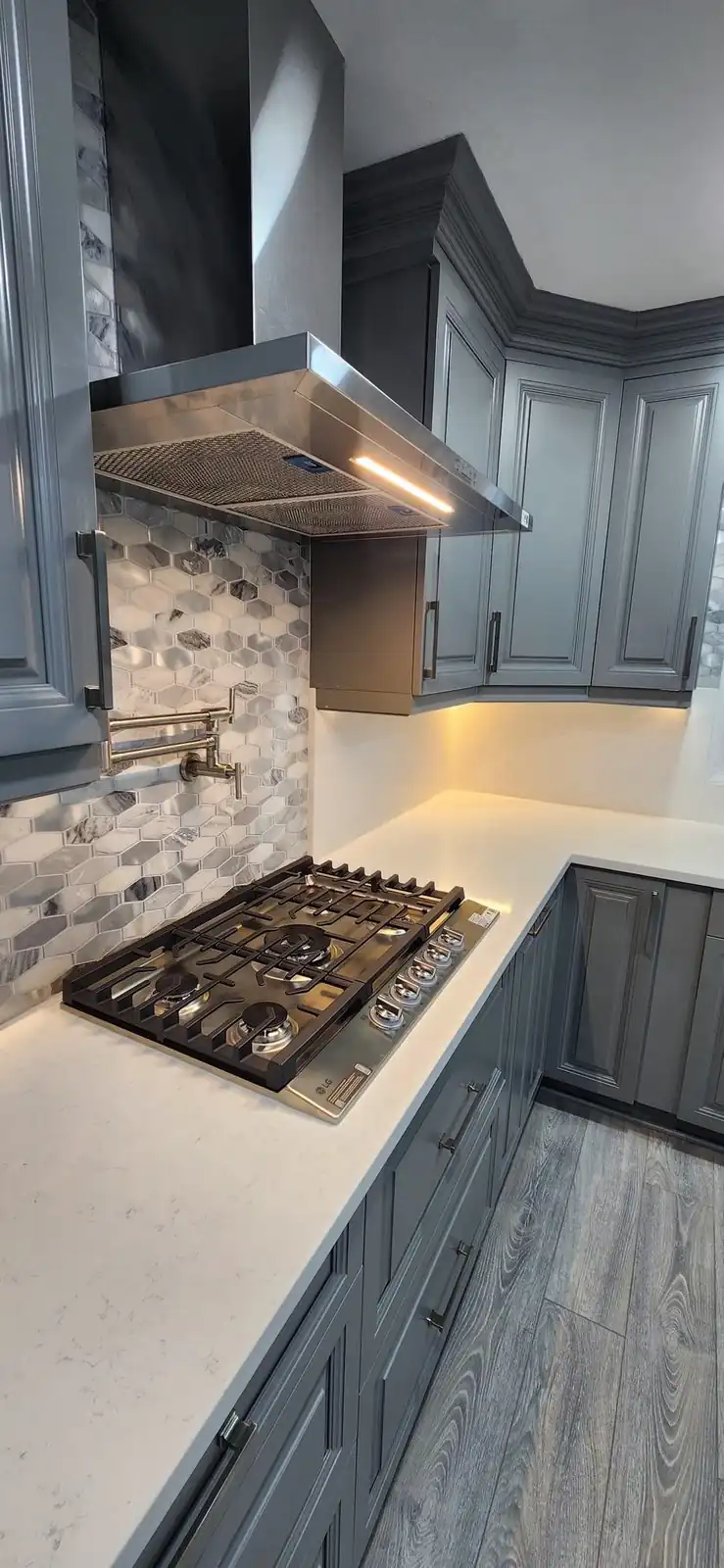 White countertop with a gas cooktop and gray cabinets – Beltway Countertops, Northern Virginia